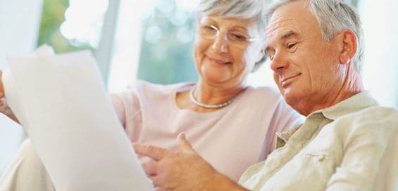 mature couple reading papers