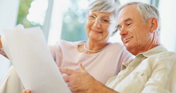 mature couple reading papers