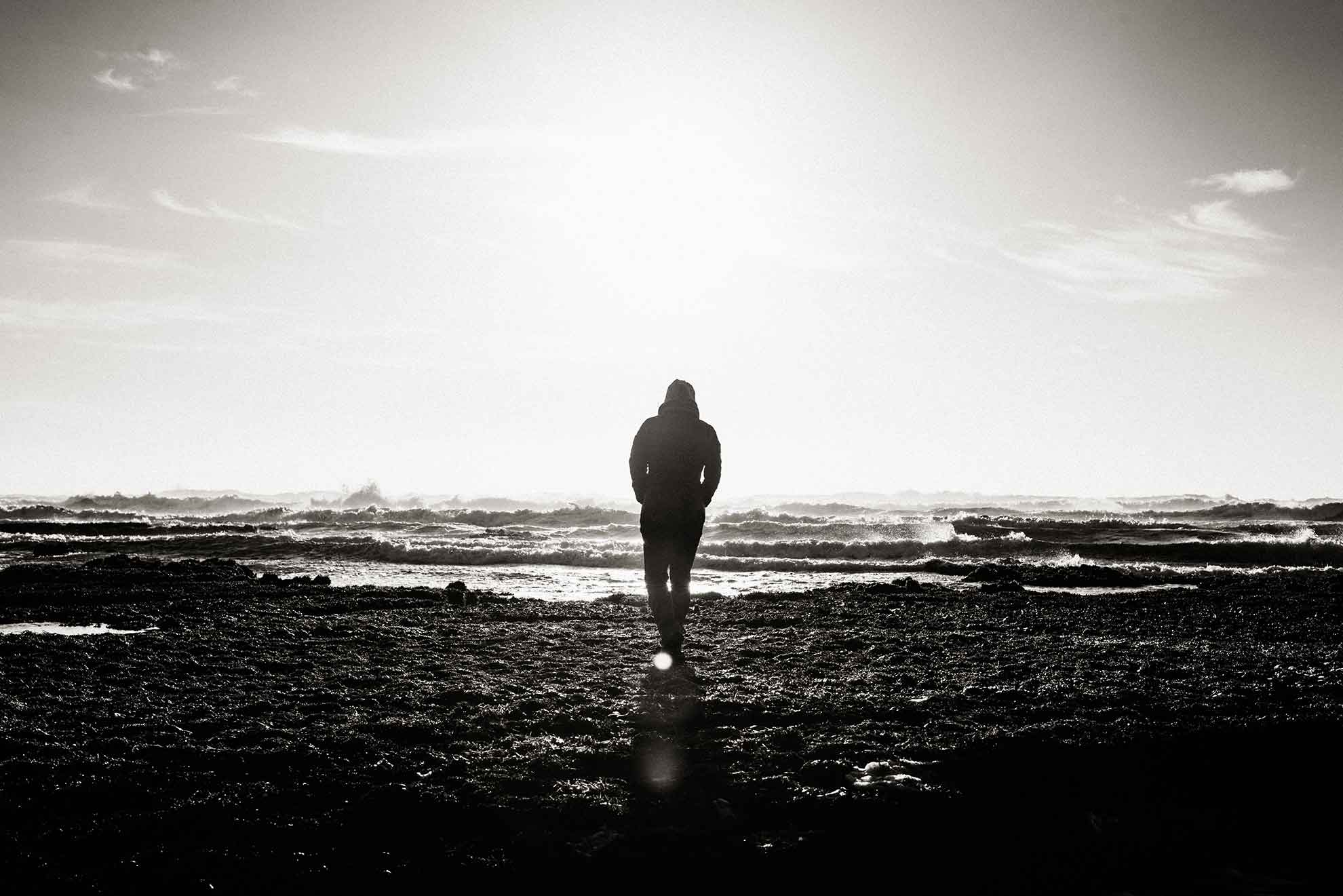 person walking on empty beach