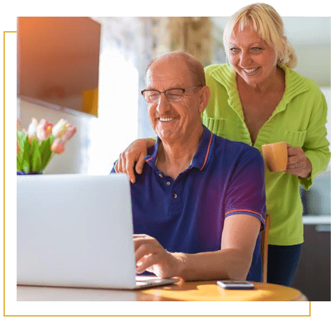 Happy couple looking at laptop