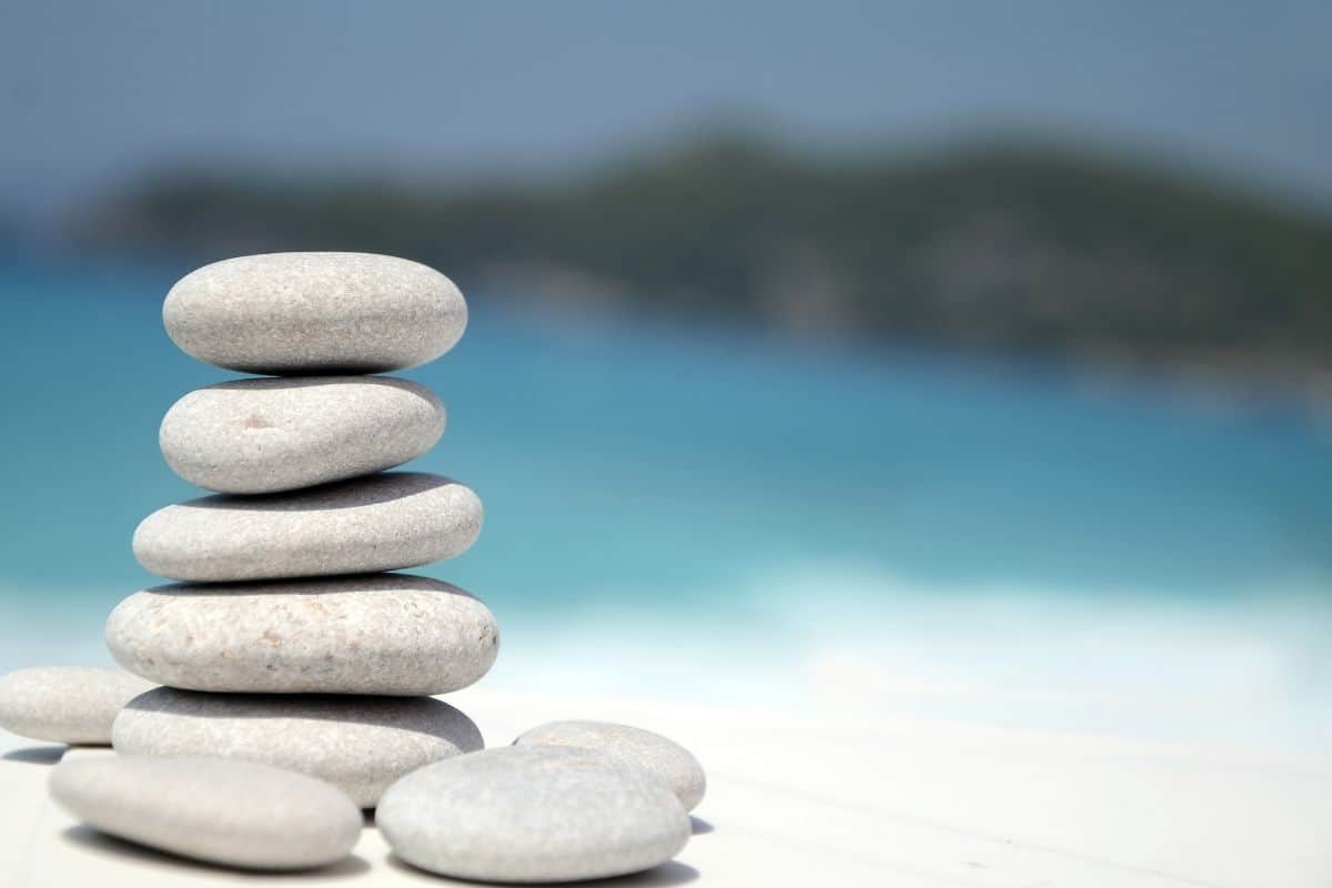 Pile of small stacked stones against a blue blurred background