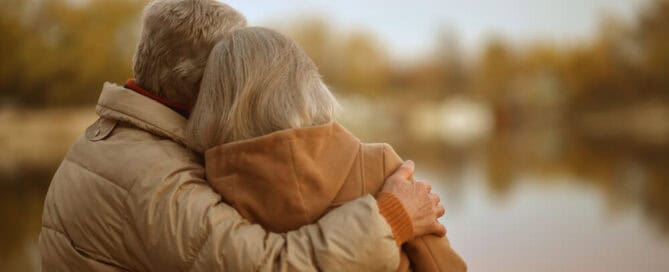 couple hug while looking at natural setting