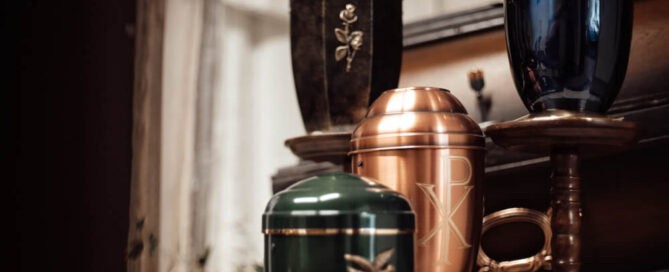 Four urns of different sizes and materials