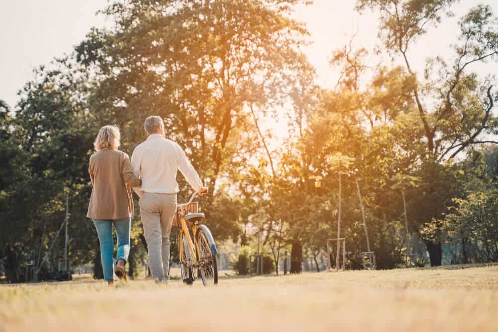green-cremation-texas couple walks with bike - green cremation Texas