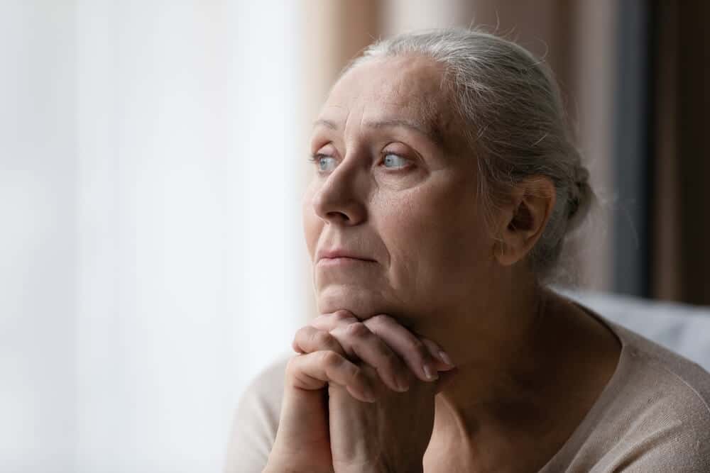 how-long-does-the-entire-cremation-process-take older woman mourns the death of a loved one